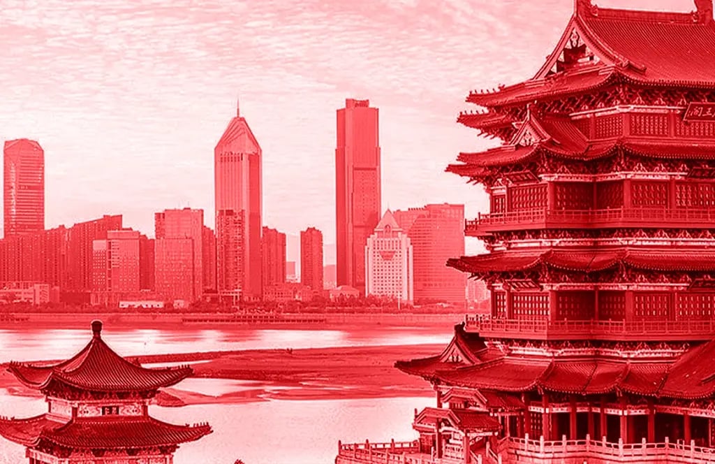 Panorama of a city with a modern skyline in the background and traditional pagodas in the foreground.